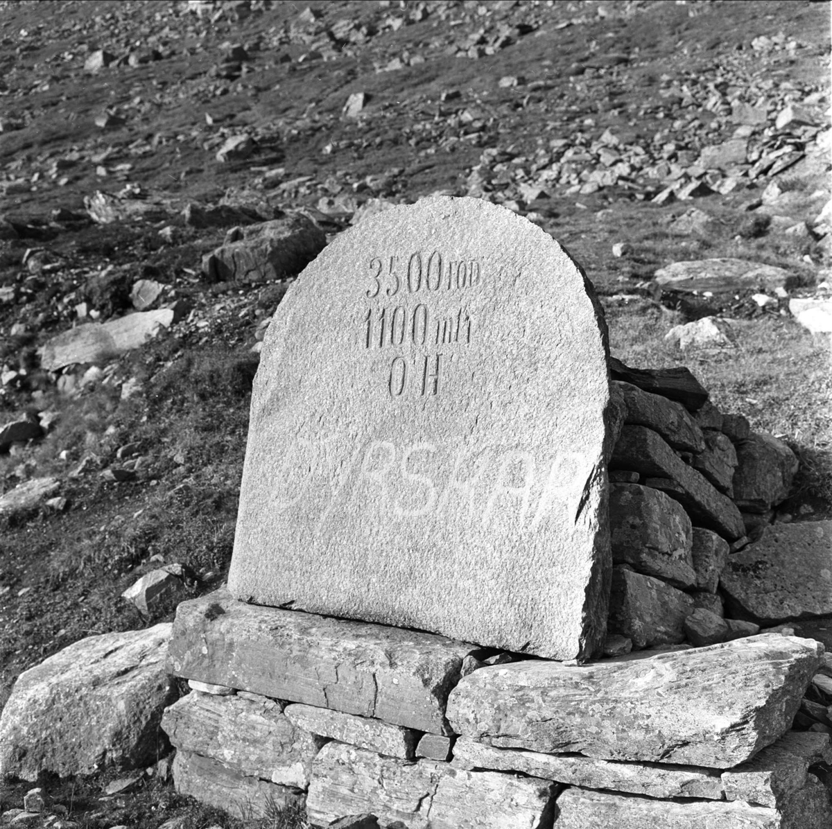 Haukeliveien, merkestein, påskrift: "3500 fod, 1100 moh, Dyrskar",  Vinje T, Haukeli, oktober 1962.