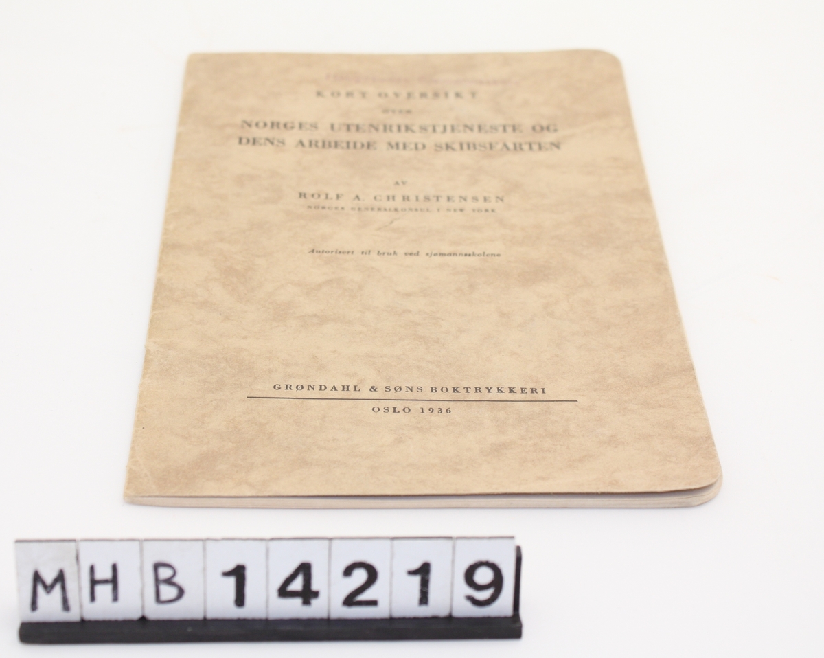 Rektangulær bok med myk pappinnbinding. Boken inneholder en kort oversikt over Norges utenrikstjeneste og dens arbeid med skipsfarten.