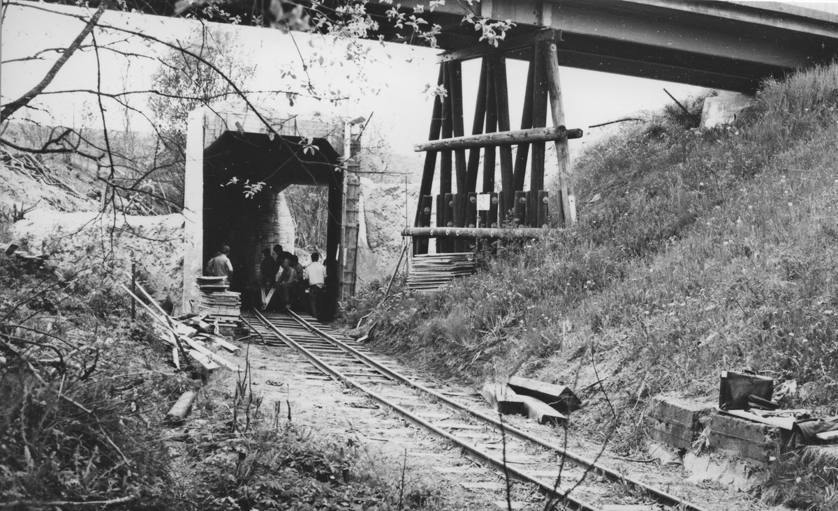 Tønsberg tunnel (kulvert) er ferdig støpt og sporleggingen gjennom tunnelen påbegynt. Fundamentet til den ganle riksvegbroen over Urskog-Hølandsbanen i forgrunnen. Broen ble revet i 1968.