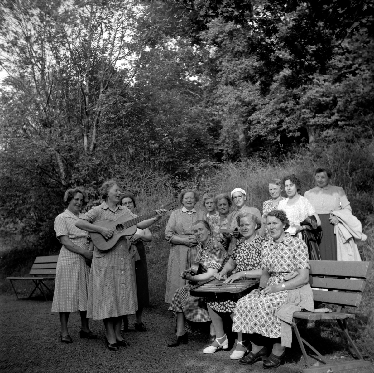 Vätterstugans sångkör. Strängspelande damer från stugföreningen samlade nedanför Vätterstugans sommarhem i närheten av Vista kulle.