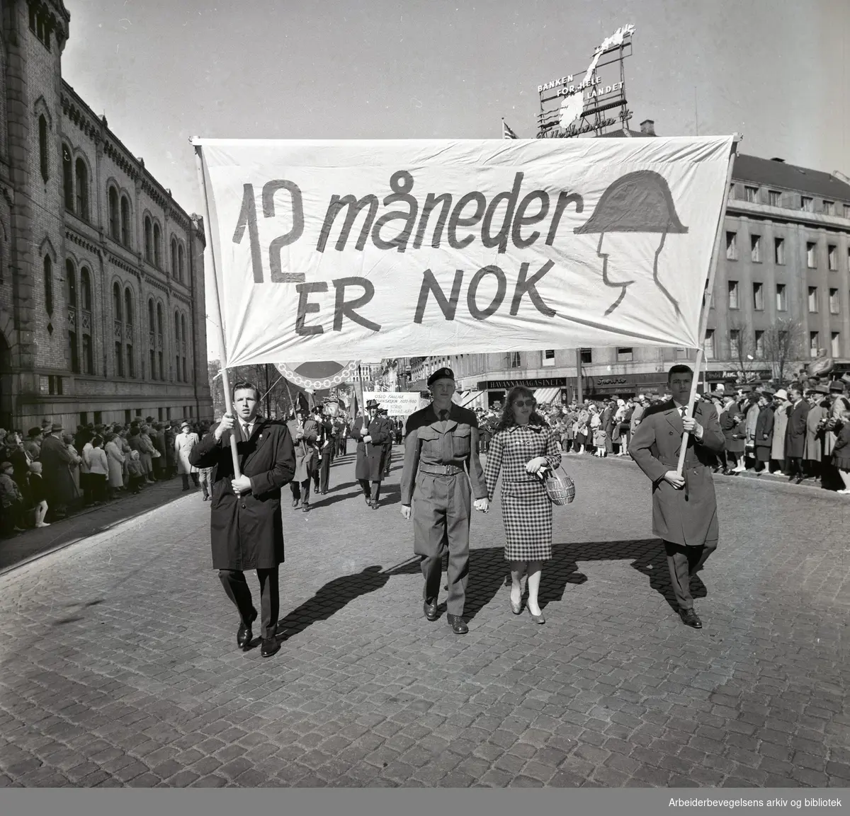 1. mai 1960 i Oslo.Karl Johans gate..Demonstrasjonstoget..Parole: 12 måneder er nok.Parole: Oslo Faglige Samorganisasjon 1920 - 1960 går i strid mot bedre kår!....