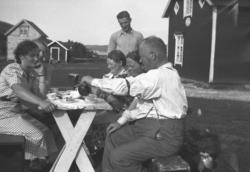 Kaffe utendørs på Mikkelsnes, ca. 1950. På venstre side av b
