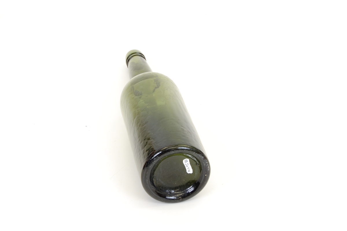 Form: Høy flaske med sirkulær grunnflate, rette vegger og lang hals

