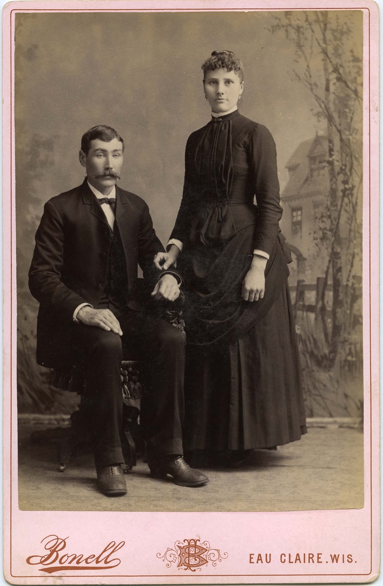 Ukjent mann og kvinne på fotoatelier i Eau Claire, Amerika. Trolig norske emigranter.