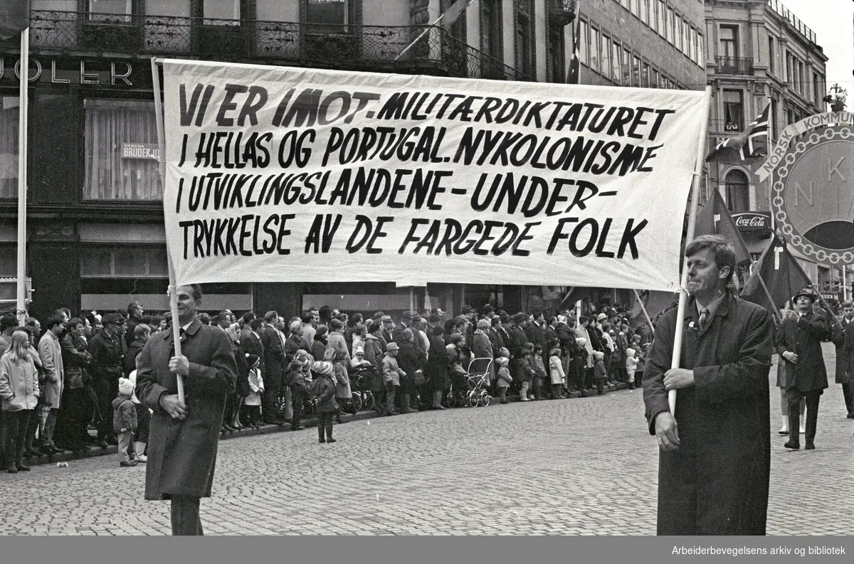 1. mai 1969 i Oslo.Demonstrasjonstoget i Karl Johans gate.Parole: Vi er i mot militærdiktaturet i Hellas og Portugal. Nykolonisme i utviklingslandene - .undertrykkelse av de fargede folk
