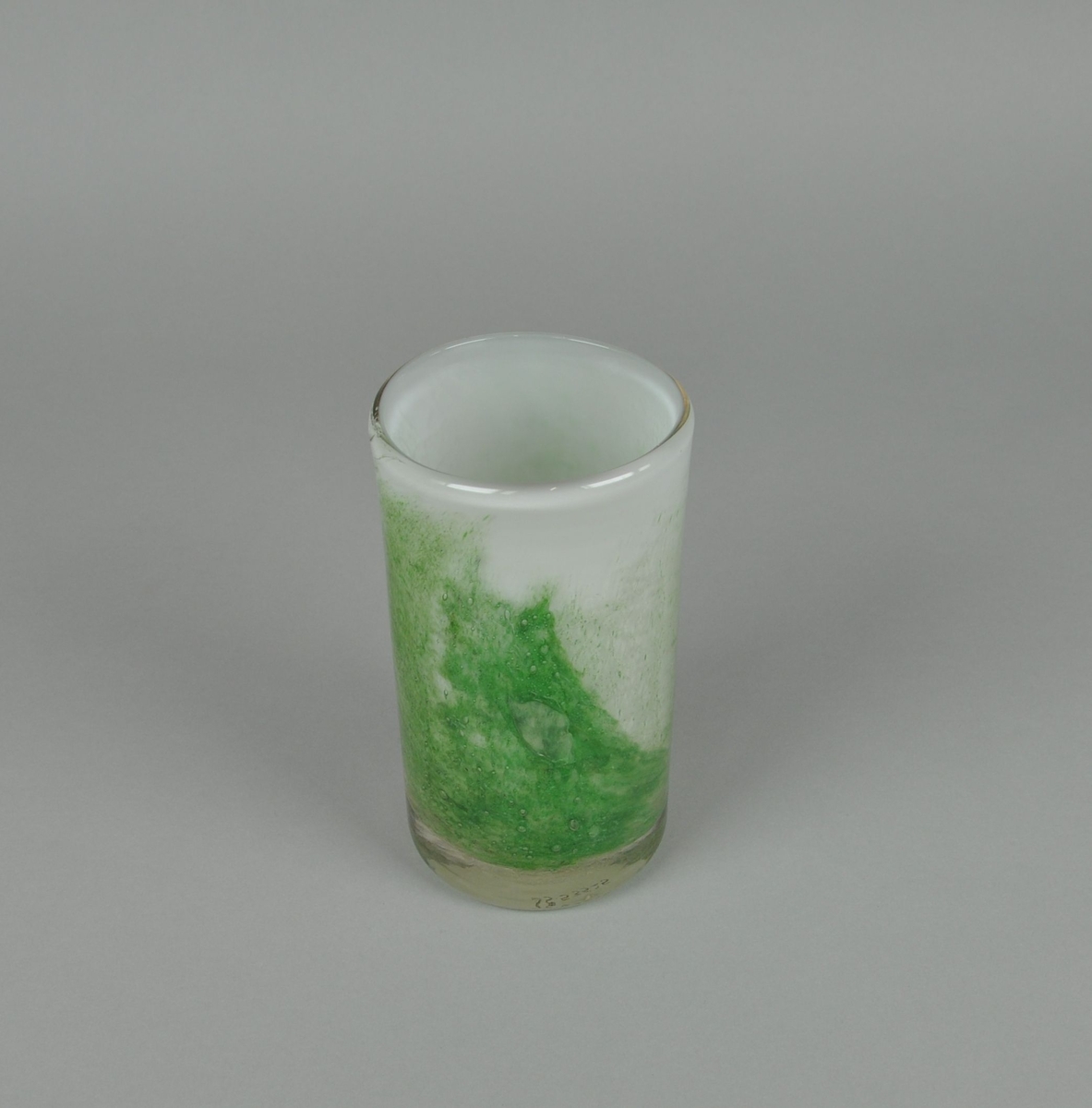 Glassblåst vase. Sylindrisk form med hvit grunnfarge og grønn dekor.