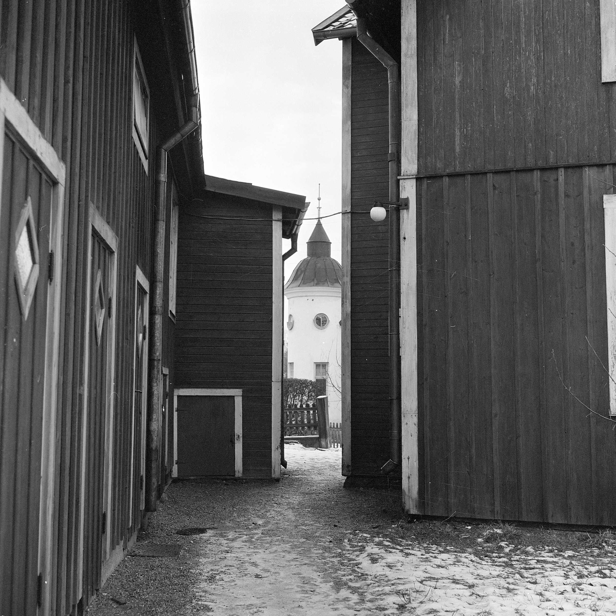 Smal passage mellan uthuslängan och ett av gårdens två bostadshus . Vy mot Arbogagatan. Gårdens byggnader revs ca 1950 - 1953
