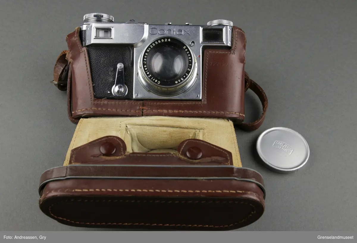Et fotografiapparat av typen Zeiss Ikon Contax 1781/8 fra 1940/41, med linse og brunt læretui.