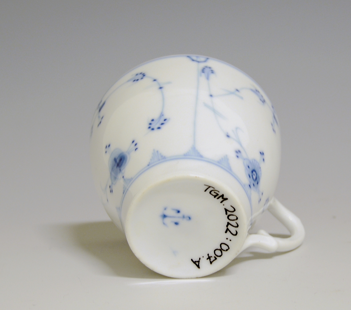 Kaffekopp av porselen med hvit glasur. Dekorert med stråmønster i blått.

Modellnr: 314.3, tilhører kaffe- og theservice 901.
Finnes i priskuranten for 1909