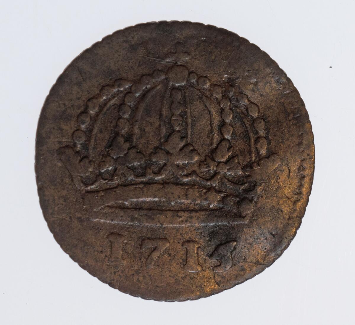Mynt, 1 daler s.m. 1715 från Karl XII tid,; Det fanns i förpackningen med inventarienummer M32325.