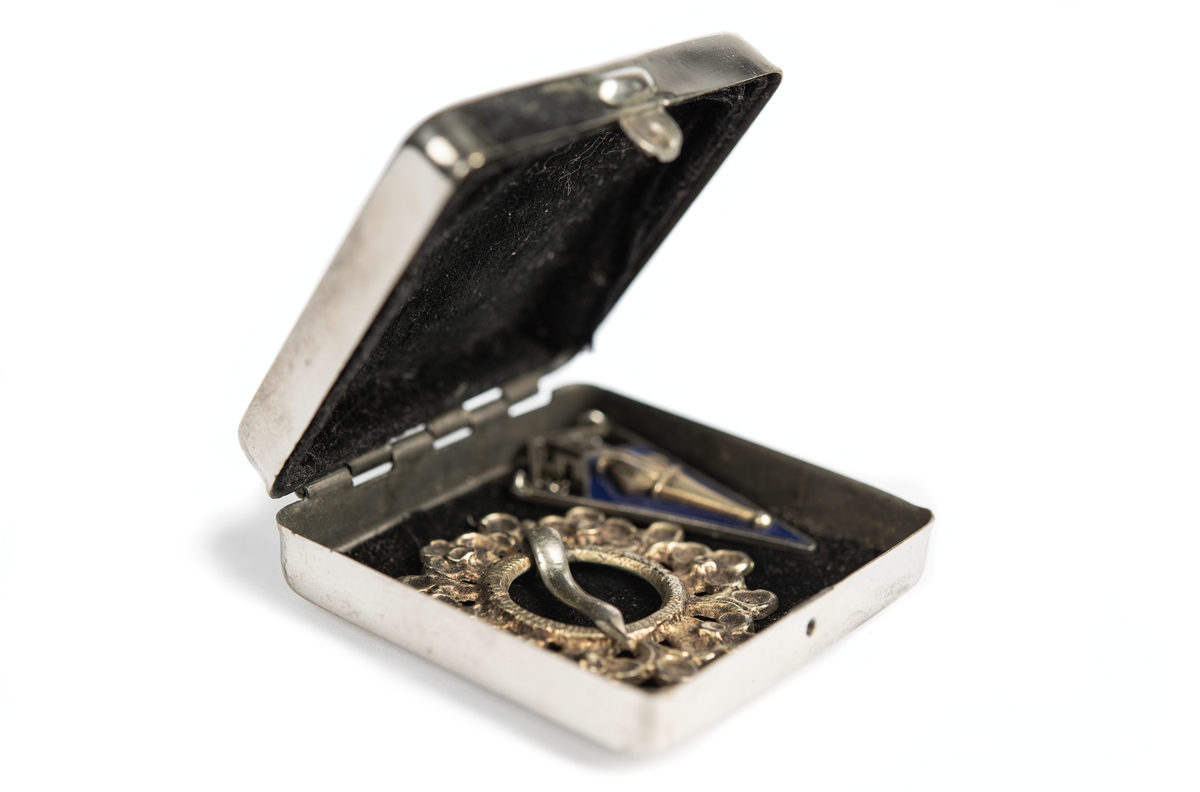 En silverfärgad metallask som innehåller ett smycke, en så kallad sölja. Togs med på flykt från Ormsö, Estland till Sverige år 1944. 
Korg. Togs med på flykt från Ormsö, Estland till Sverige år 1943. 
