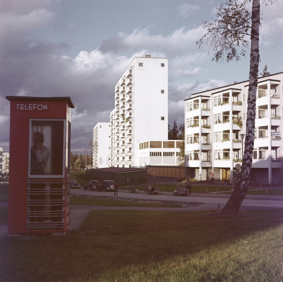 Drabantbyen Bøler med blokkbebyggelse fotografert i oktober 1958. En person snakker i telefonen i en rød telefonkiosk.
