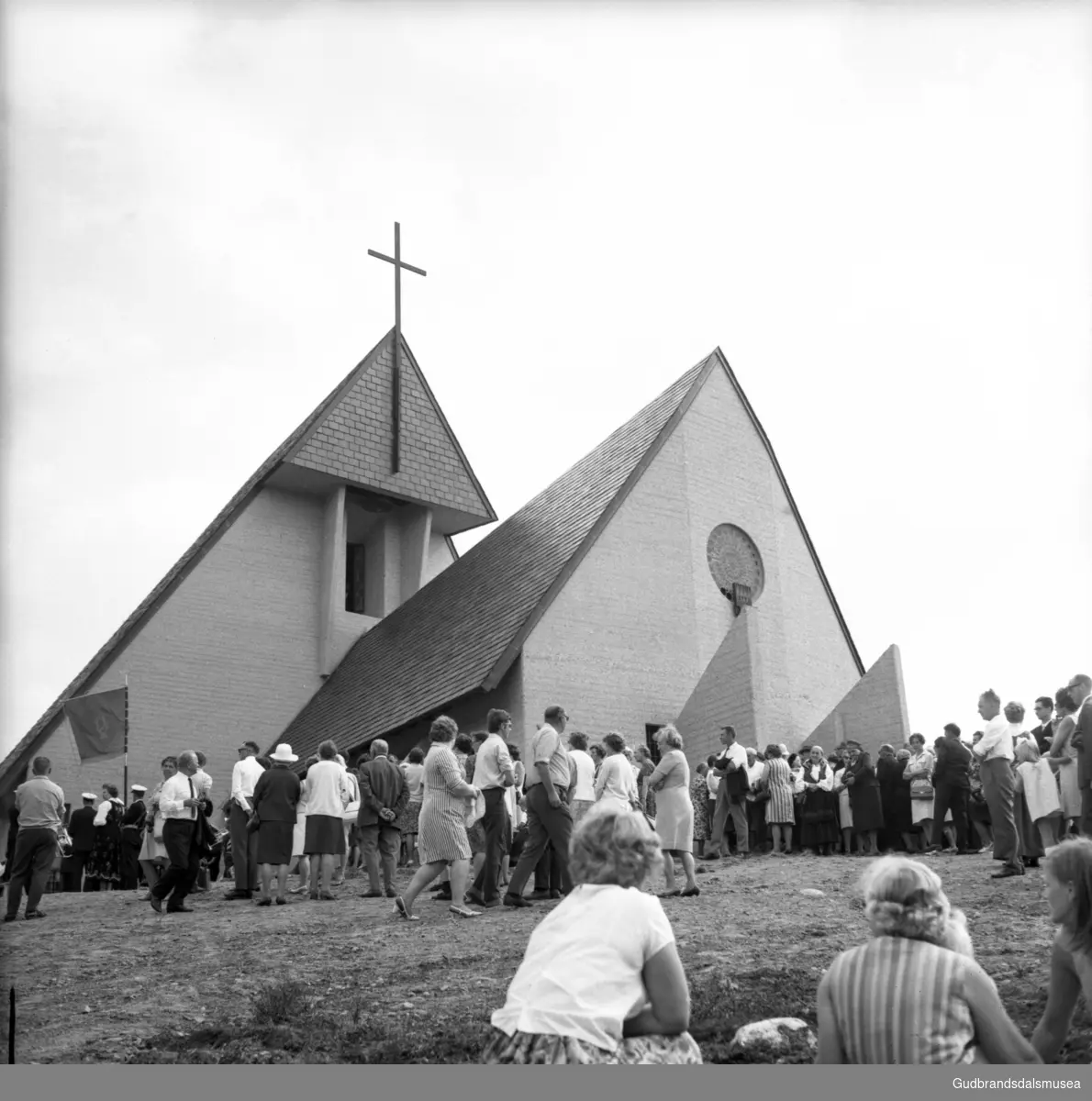 Frå kyrkjebakken rundt Eysteinskyrkja på Hjerkinn på vigslingsdagen 3. august 1969. Prosesjonen med biskop, prestar med fleire på veg opp til kyrkja.