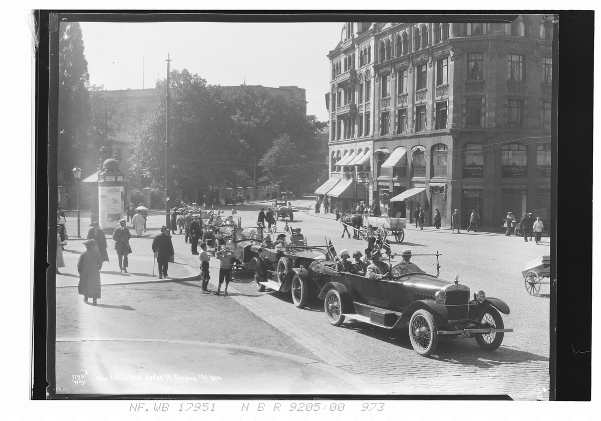Medlemmer av Oslo Rotary klubb sitter i biler på vei opp Akersgata på vei til Rognlien. Påskrevet fotografiet "Kria Rotary Klub - Avsted til Rognlien 16/7-1924".