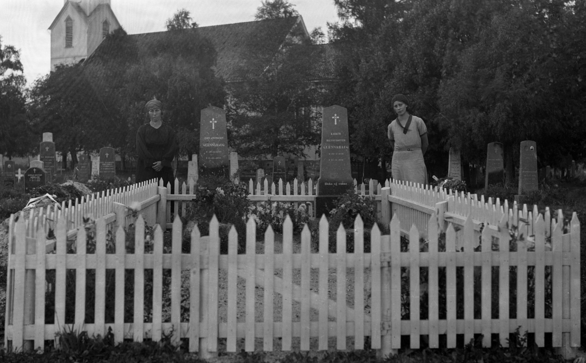 To kvinner ved gravsteinane til John og Kjersti Glennahaug.  Bø kyrkjegard.