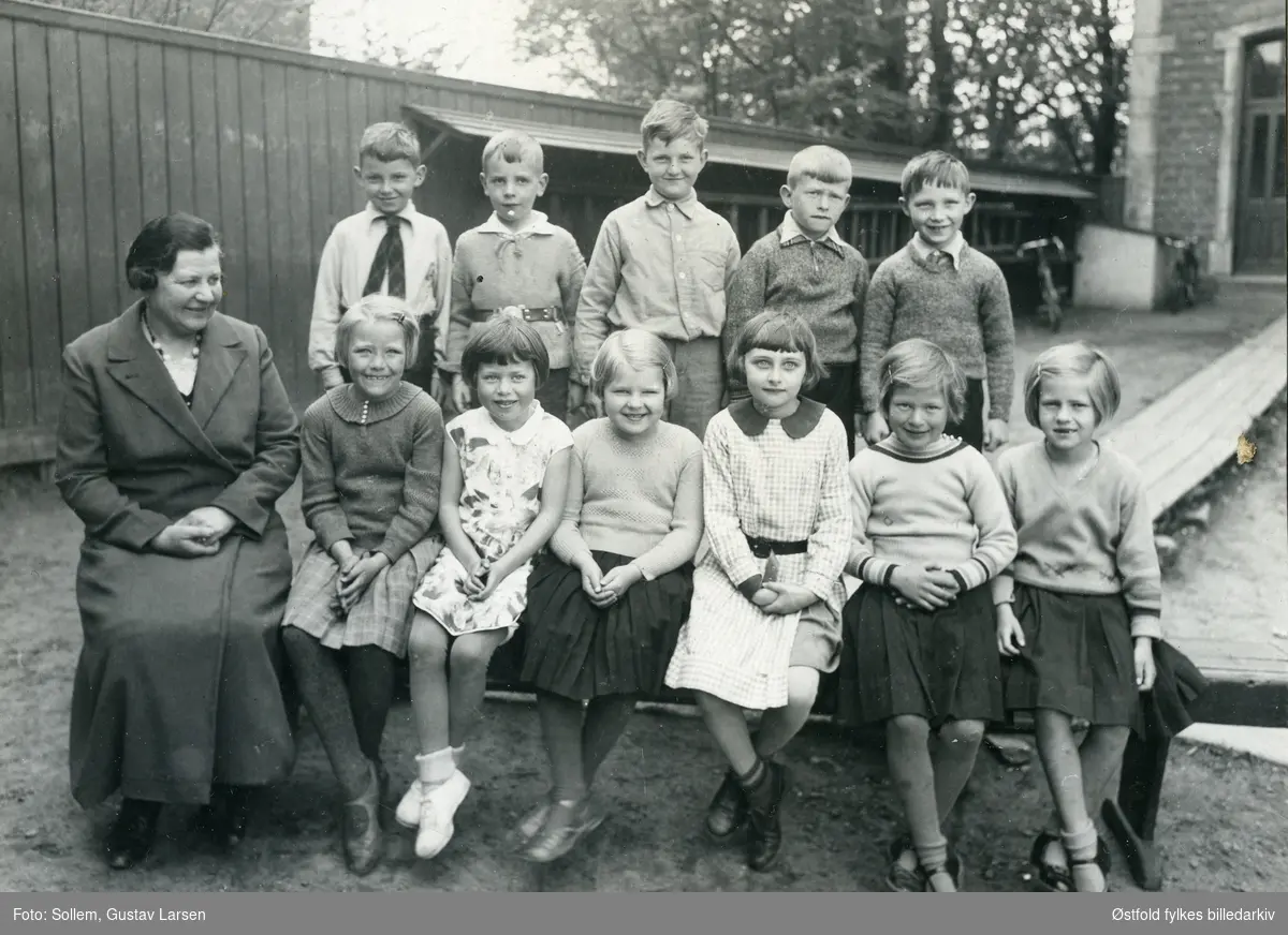Vestre Fredrikstad pigeskole også kalt Pikeskolen (gutter ble tatt opp fra og med 1898), utenfor skolen i Cicignongata 16 i Fredrikstad. Klasse  i småskolen fotografert ca. 1932. Fredrikstad Handelsskole overtok lokalene i 1932, altså er bildet antakelig fra før 1932 eller tidligere.
Jenta i fremste rekke  (nr. 4. fra venstre) er Ingrid Nordby,