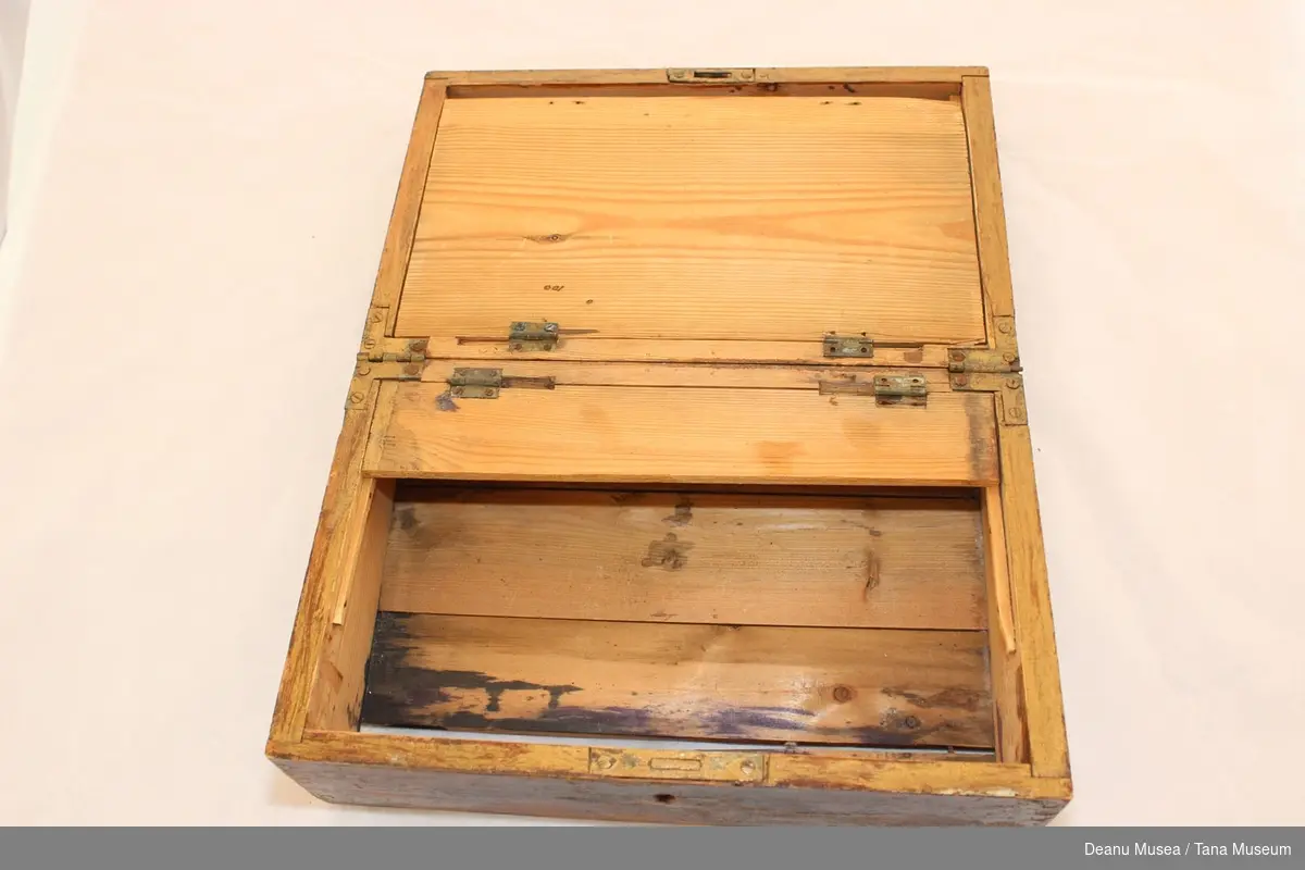 Brunlakkert kiste i tre med lås, nøkkel mangler. Innvendig lokk, tynn treplate er knekt.