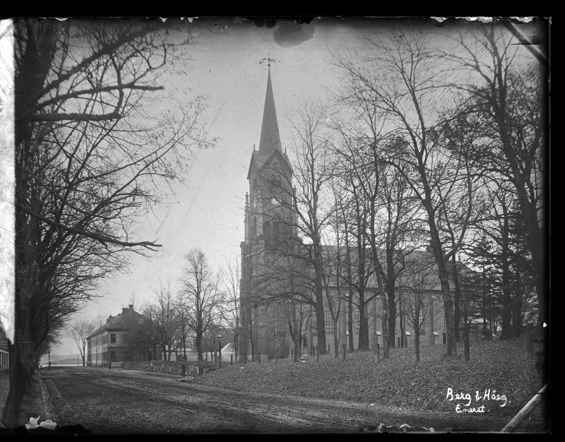 Horten kirke på Karljohansvern, sett fra Nedre vei. Løvtrær uten blader.