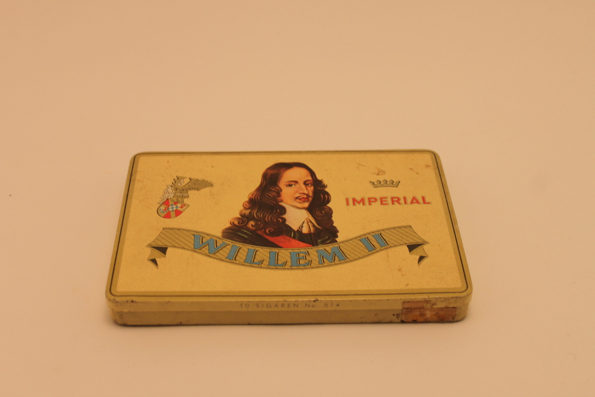 Plåtask för cigarrer med ett mansporträtt och texten Willem II. En vapensköld samt en krona med texten Imperial under. 
