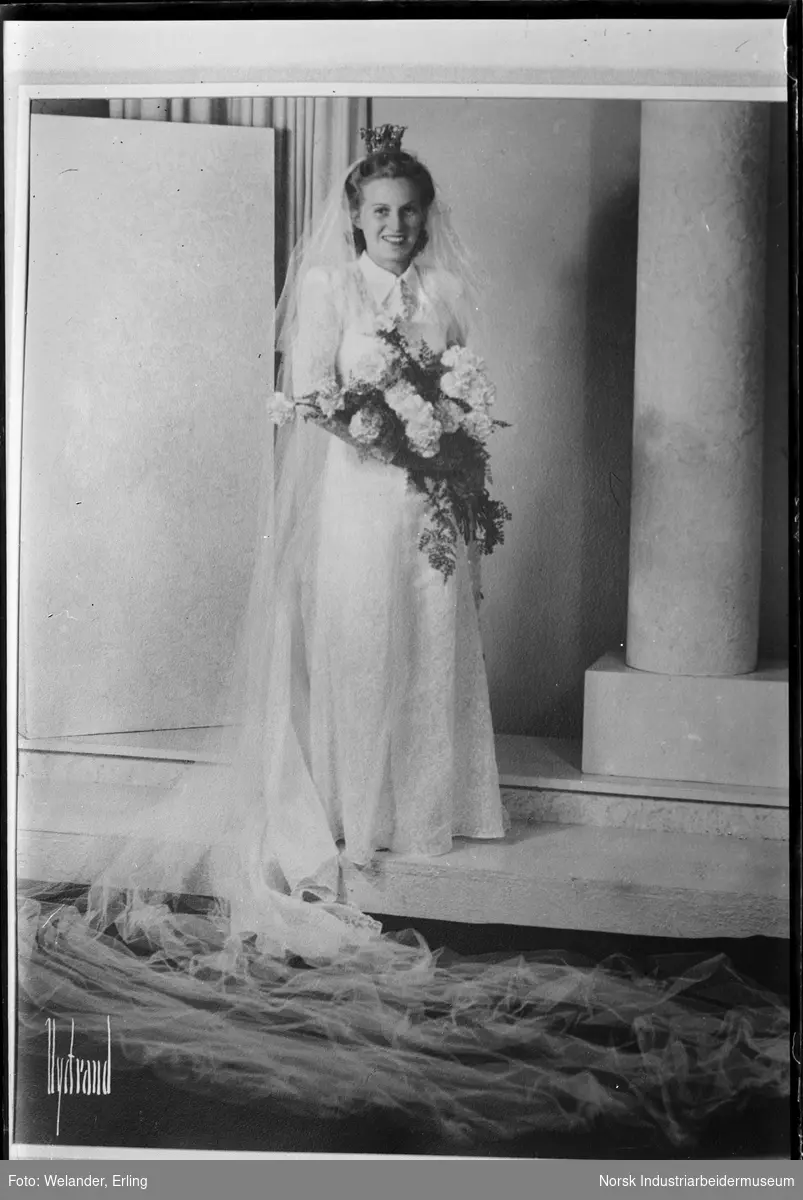 Reprofotografi av brudebilde. Brud med brudekjole og slør, brudebukett i hendene og krone på hodet.