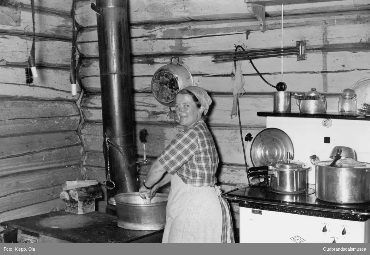 Ida Stulen (f. 1914) vaskar opp på komfyren