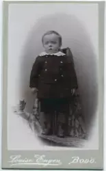 Portrett av en liten gutt i korte bukser, lærstøvler, dressj