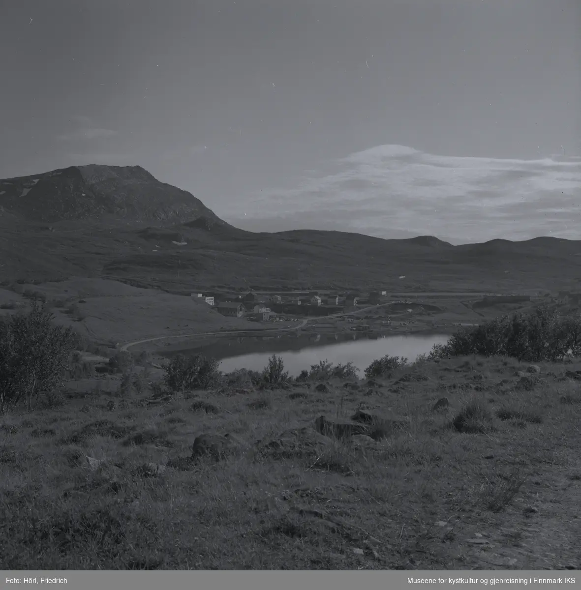 Storvannet i Hammerfest sett fra Kallandskogen. I midten av bildet ser man bebyggelsen rund munningen av elva, et området som kalles for "Tunnelbakken" og der elverket ligger. I bakgrunnen til venstre ser man Tyven fjellet.