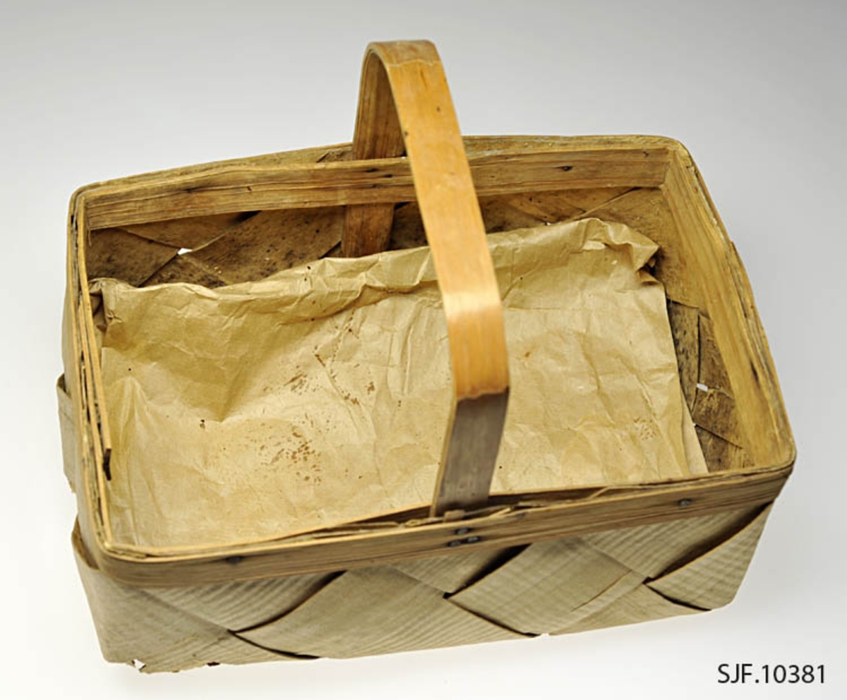 Sponkurven er skråflettet, og har en bøyd hank. Sponene er jevnbrede, og er maskinhøvlet.

Bunnen har en rektangulær form. Sponene er vikt opp, og sidene er rette. 
Kanten danner en form tilsvarende bunnen. På kanten er det lagt på et smalere spon på hver side som er festet med metallstift. 

Innvendig og utvendig skjøt ligger på hver sin kortside.
Hanken ligger på innsiden av de flettede sidene, og er festet mellom flettet side og indre kantspon. Hanken består av et tykkere spon som delvis er kløyvd i to. Spiker og stifter i kurvkant er rustne.

Kurven har tydlige spor etter jordslag. 

Det ligger et dobbelt gråpapir i bunnen på kurven.
