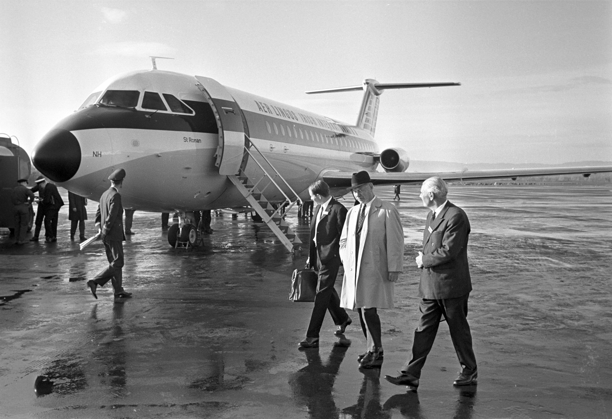 Serie. Menn fra Braathens SAFE inspiserer jetflyet fra "Aer lingus irish international". Et propellfly er i ferd med å lette i bakgrunn. Fotografert oktober 1965.