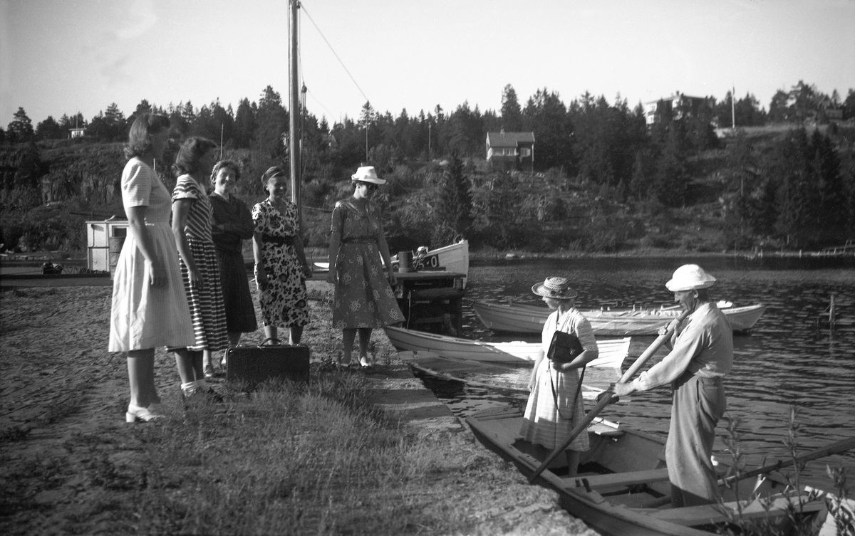 Fem kvinner, deriblant Guri, Siri og Dordi Arentz, tar imot Sonja og Otto Sheen på Nesbrygga på Nøtterøy. Fotografert høsten 1948.