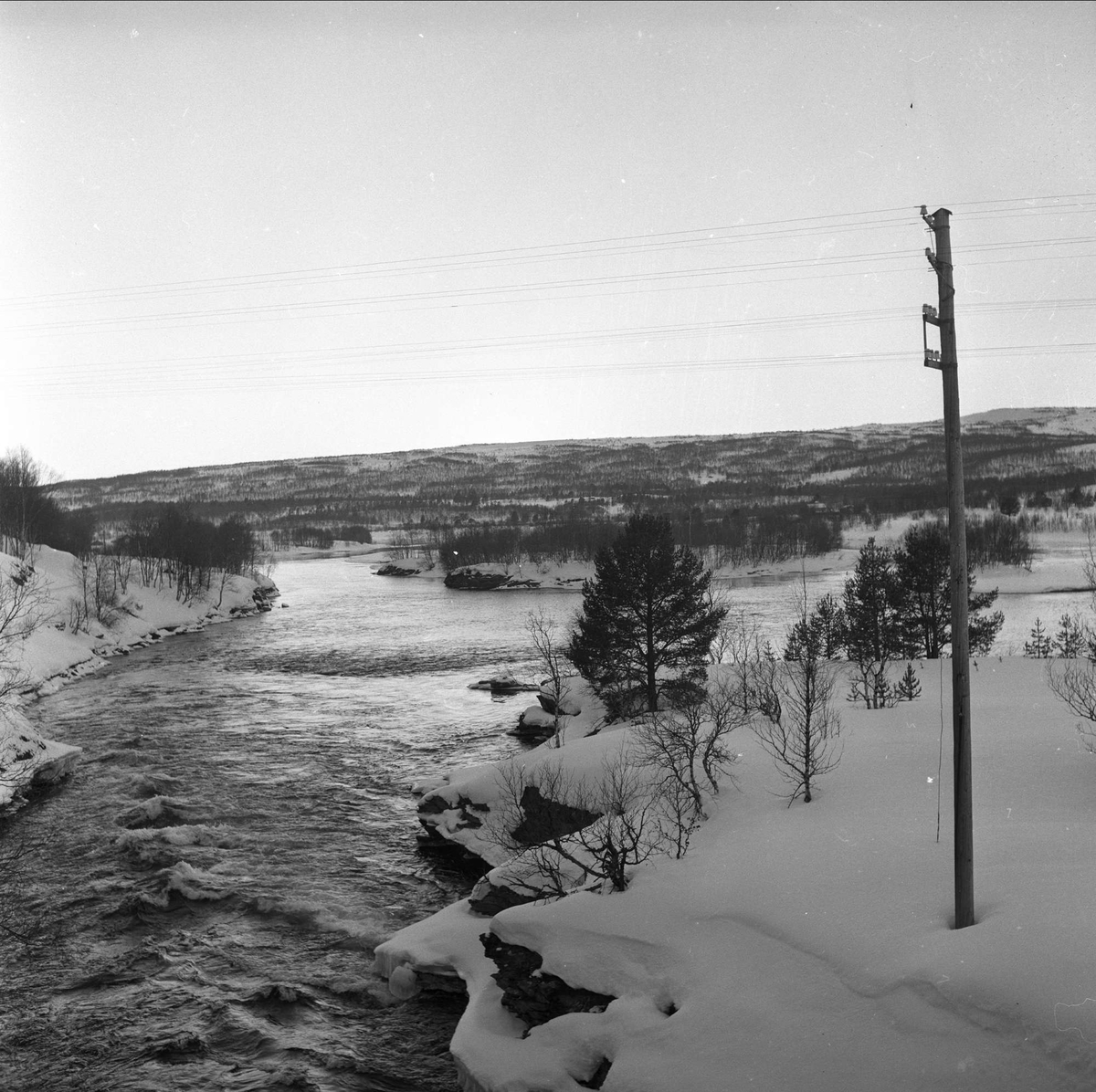 Røros, Sør-Trøndelag, mars 1959. Landskap med elv.