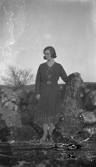 Enligt notering: "Ett kvinnoporträtt vid stengärdesgården. Hilda Tanberg Solberg 1926".