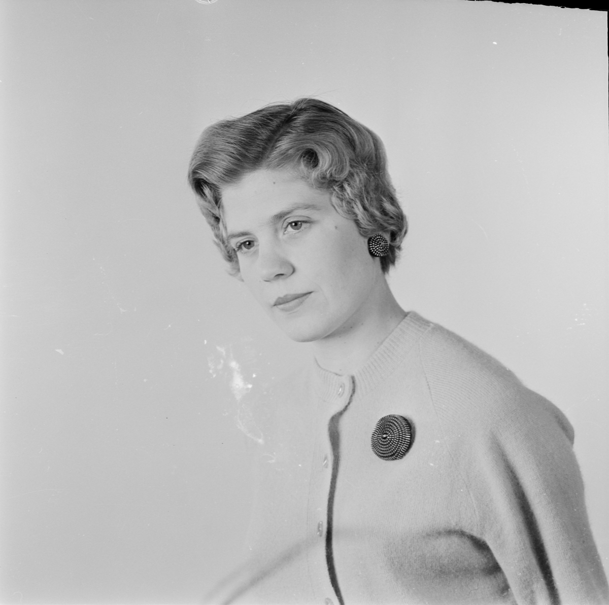 Kvinna med brosch och örhängen, Uppsala 1956