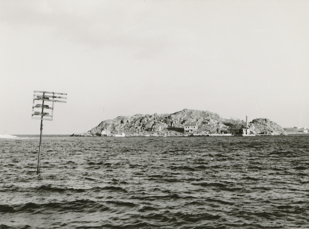 Prospektfotografi av eldre, forlatte industribygninger på Furkenholmen, Godøy. Her ble det drevet sildeoljefabrikk fra 1926. Tidligere var holmen et fiskevær.