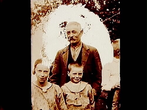 En äldre man och två barn.
Fru Elin Karlsson