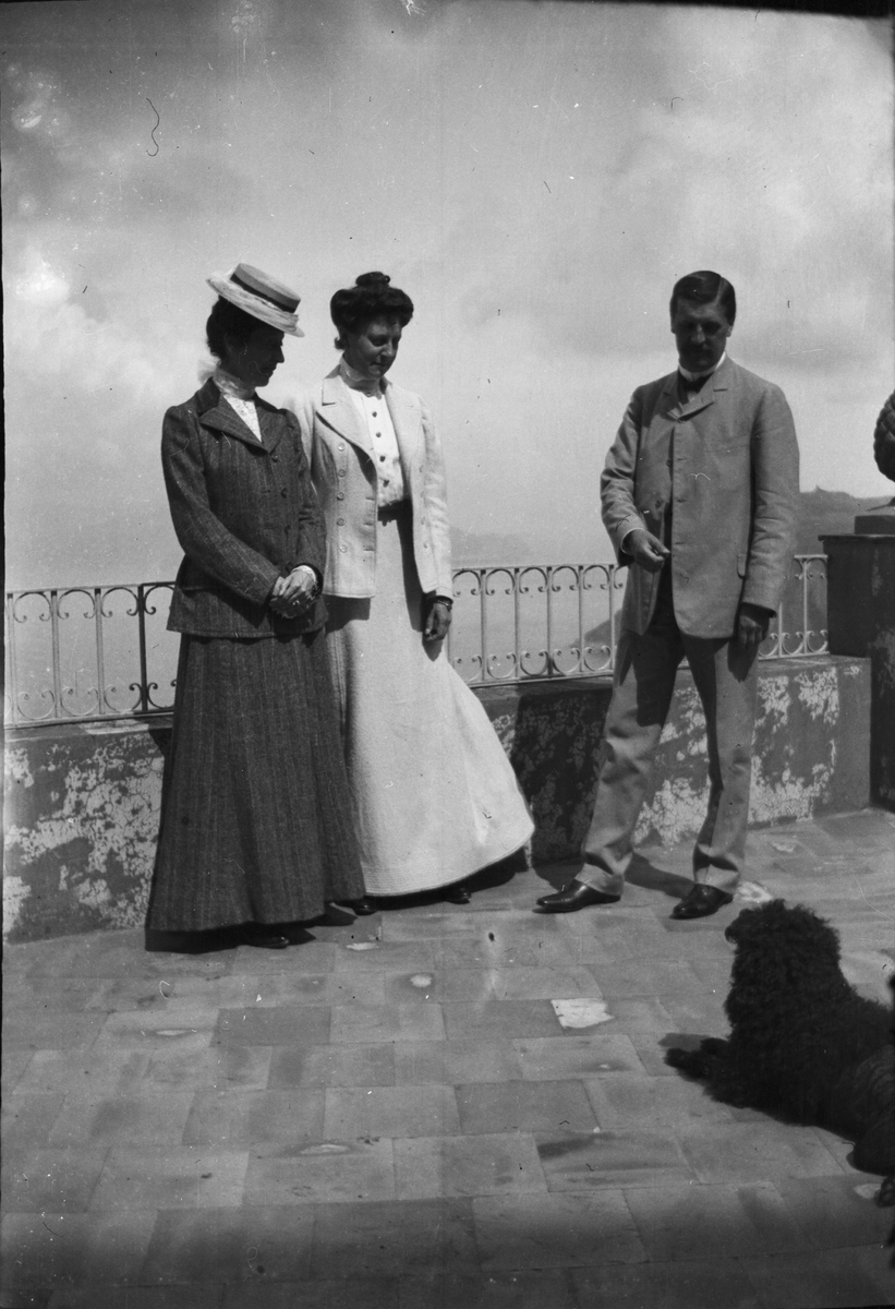 Drottning Victorias bilder. Två kvinnor, en man och en hund. Mannen är möjligen Axel Munthe.