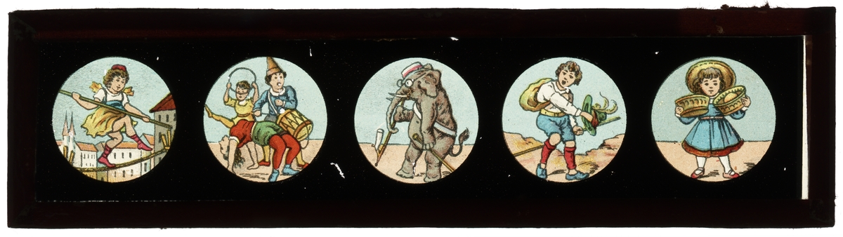 Målad bild på glas för Skioptikon/Laterna magica.
Motiv av lindansande flicka, trumslagarprojke med akrobater, elefant, pojke samt flicka.
