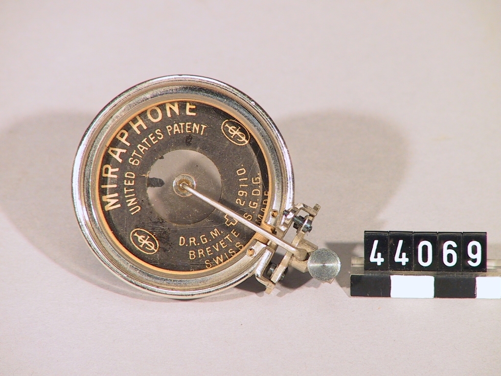 Miraphone, ljuddosa till grammofon, tillverkad av förnicklad mässing. Ligger i en rund ask, askens diameter: 60 mm.