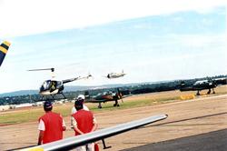 Lufthavn/Flyplass. Over flyplassområdet kommer et helikopter