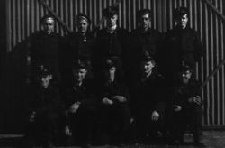 Portrett. En gruppe personer i uniform, poserer for fotograf