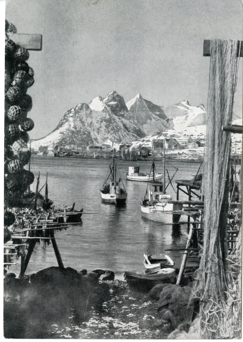 Postkort. Kystlandskap med båter og fjell i Reine i Lofoten.