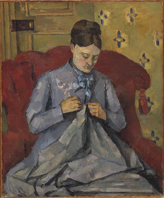 Denna målning är ett av de många porträtt Cézanne utförde av sin hustru Hortense Fiquet. De hade träffats 1869, när hon arbetade som modell. Deras son föddes 1872, men de gifte sig först 1886 – Cézanne oroade sig länge för sin fars reaktion. Cézanne daterade sällan sina målningar. Men bakgrundens gulaktiga tapet med sitt karaktäristiska blå mönster har i det här fallet gjort det möjligt att tidsbestämma porträttet. Just denna tapet fanns nämligen i den Parislägenhet som paret hyrde under en kort period 1877.