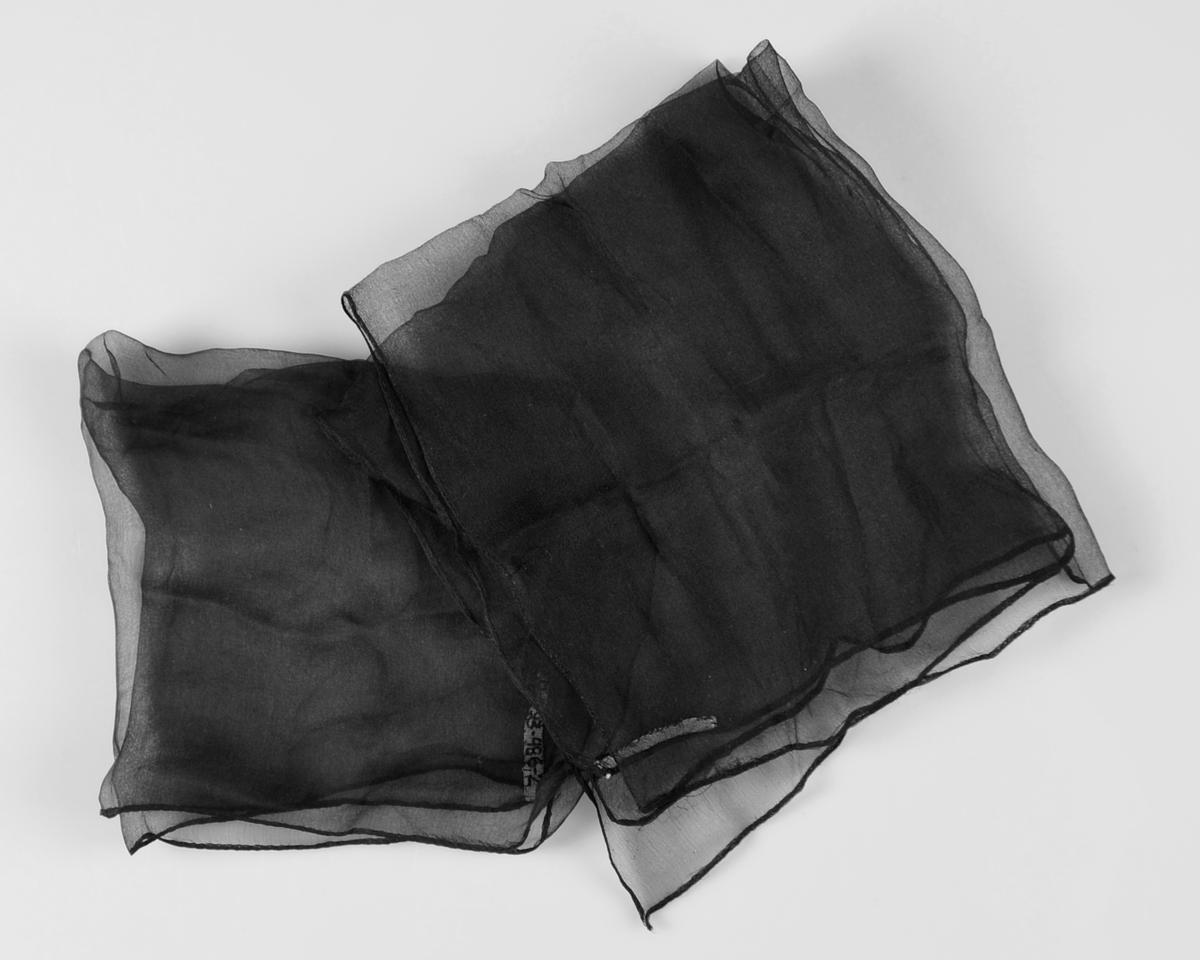 To svarte, firkanta tørkle i gjennomskineleg lett stoff.