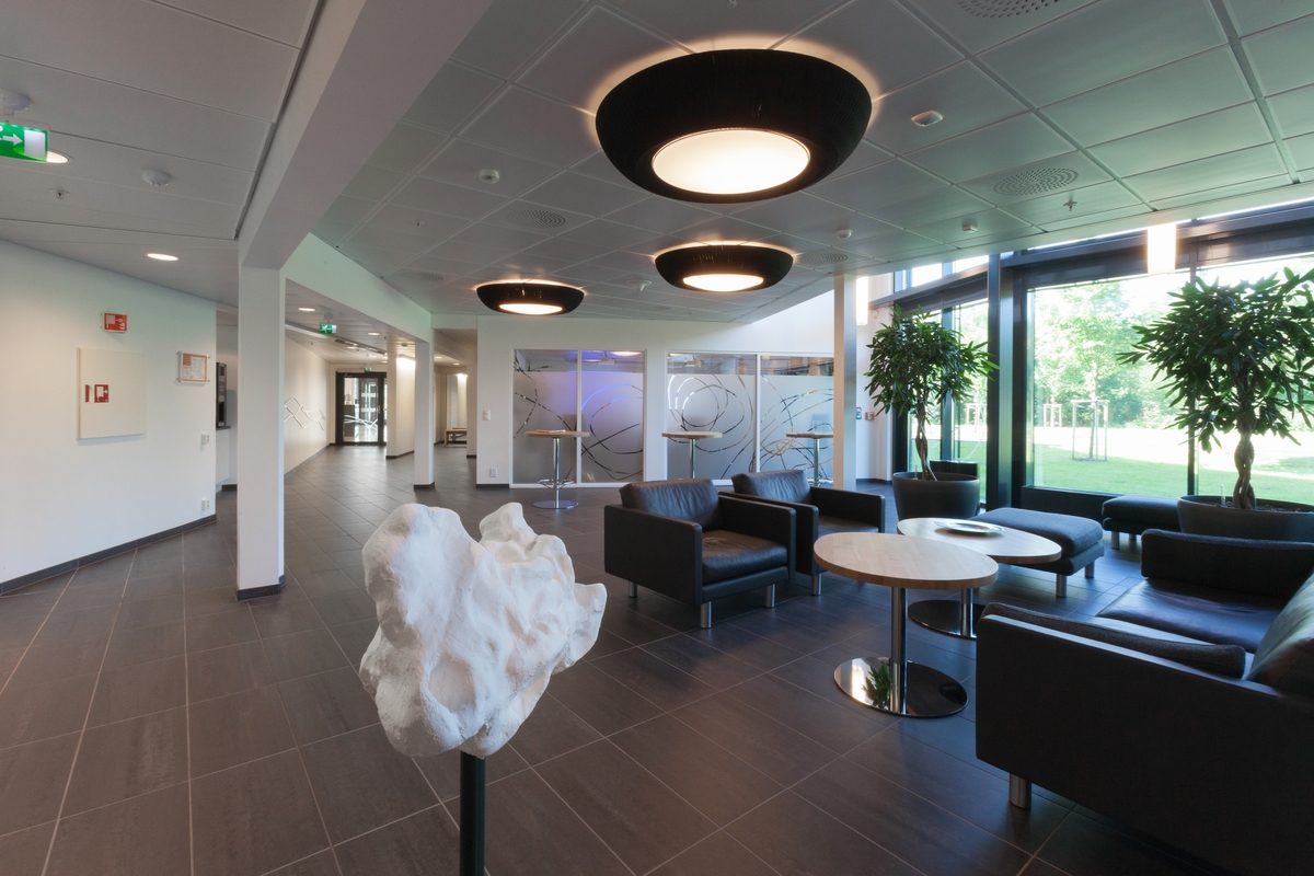 Kunstneren inviterte alle de ansatte i Petroleumstilsynet til være med på å lage et totem til institusjonen. Et totem er en families eller klans emblem, hogget ut i tre. Det er gjerne et ikke-menneskelig vesen, og noe som klanen assosierer seg med.

"Totem I" står inne i vestibylen, mens den større "Totem II" står ute i vannspeilet i atriet og kan betraktes fra kontorene til ansatte ved flere statlige institusjoner.  Der står den og minner om at ikke alt er målbart og formålsrettet.  Noen ting blir til ved innskytelser og luner, og spiller sin rolle i verden som brudd med det vante.