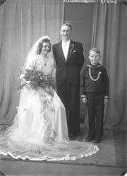 Portrett. Brudegruppe på tre. Brud, brudgom og ung gutt. Bes