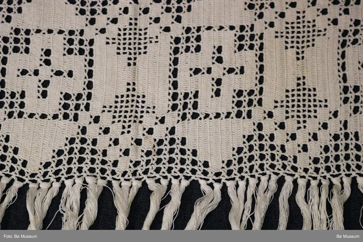 Hekleblonde med likearma kors inne i firkant, små ruter og holmønster dannar trekantmønster oppe og nede.