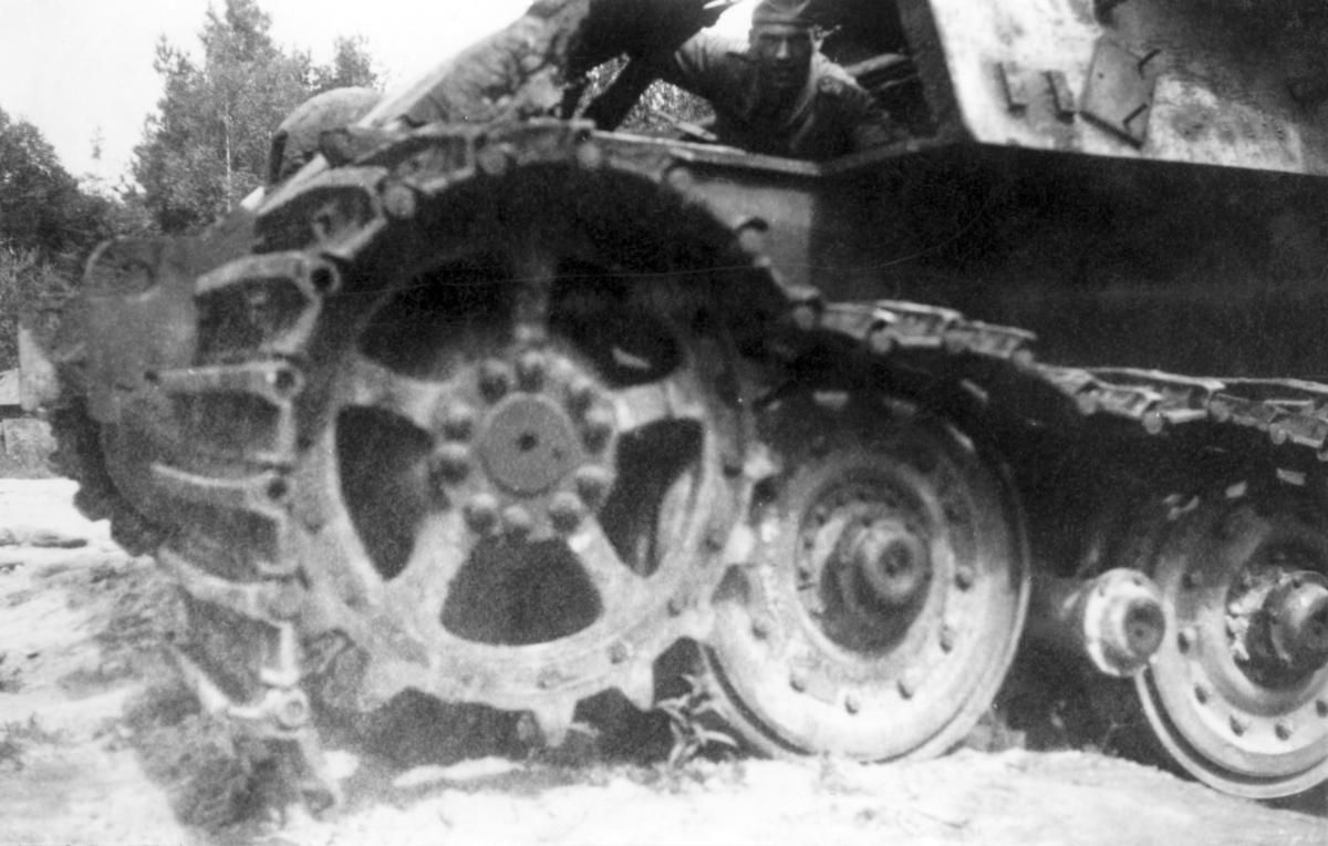 Tysk stridsvagn Kungstiger som beskjutits och analyserats på Karlsborgs provskjutningsfält 1950.
Chassit uppskuret vid förarplats och bandet avsprängt.
Från förarplats syns fu Ericsson P 3.