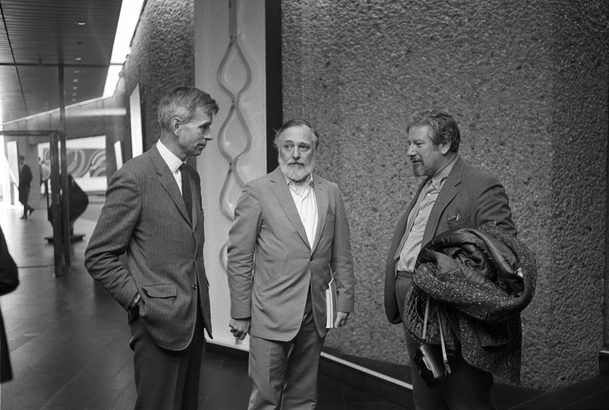 Skuespiller og regissør Peter Ustinov besøker Henie Onstad Kunstsenter på Høvikodden. Her er han til høyre i samtale med den danske maleren Asger Jorn i midten og direktør Ole Henrik Moe til venstre.