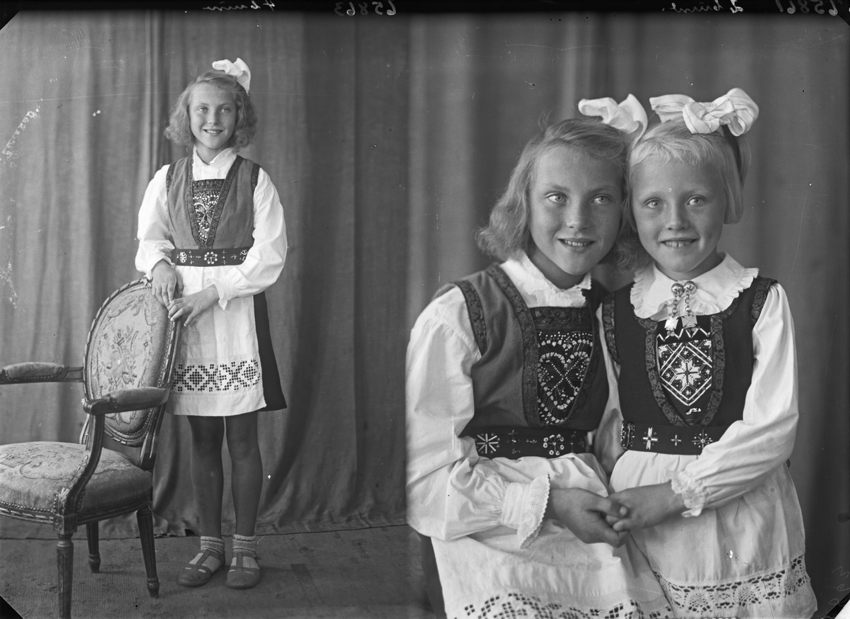 Gruppebilde. Familiegruppe på to. To unge piker i nasjonaldrakt med sløyfer i håret. Søstre. Bestilt av Erling Nilsen. Strangt. 181