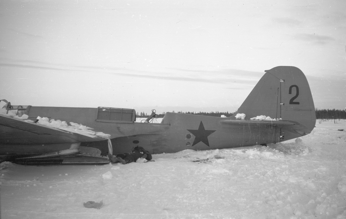 Nedskjutet sovjetiskt bombflygplan SB-2 ligger på ett fält vid Svenska frivilligkåren i Finland, F 19. Mitt- och stjärtparti.